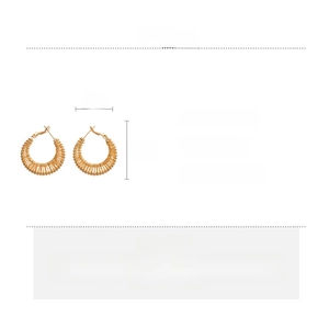 Macro view of gold woven geometric hoop earrings with copper material and size specs