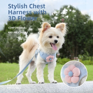 Detail of light blue denim pet harness with 3D floral accent and breathable mesh fabric