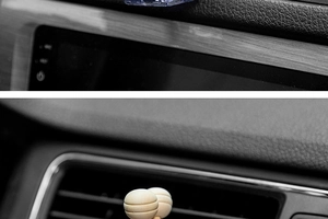 Detailed close-up of a wooden ball car diffuser clip installed on a vehicle air vent