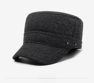 Detail of dark grey wool blend flat top cap with leather strap and metal rivets