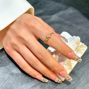 Elegant gold butterfly ring with twisted band and crystals on female finger