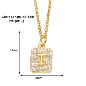 Detail shot of golden rectangular pendant necklace with sparkling cubic zirconia letter T