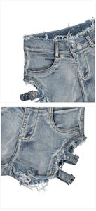 Detalle de pantalones cortos vaqueros azul claro con aberturas y hebillas laterales