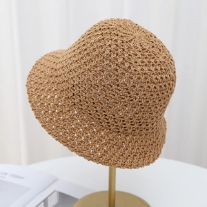 Detail of hand-woven hollow crochet patterns on a breathable summer straw bucket hat