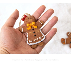 Close-up of gingerbread man Christmas tree ornament with realistic biscuit texture and bow