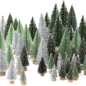 Mini bottle brush Christmas trees in various sizes with natural wooden bases and snow effect