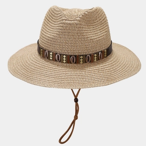Detailed weave of straw cowboy hat featuring shell strap and adjustable wind rope