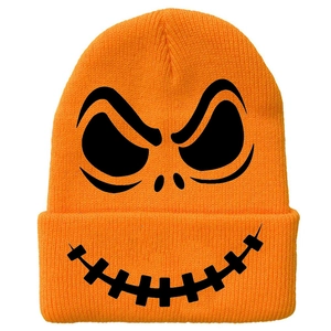 Close-up of bright orange knit beanie featuring a black spooky skull face pattern