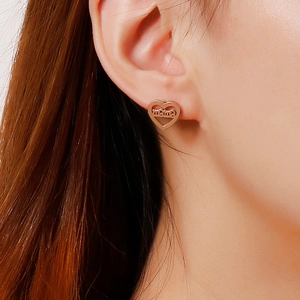 Rose gold heart-shaped mama earrings in stainless steel on model for Mother's Day