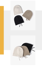 Detail of cable knit beanie edge featuring drawstring accents in neutral color options