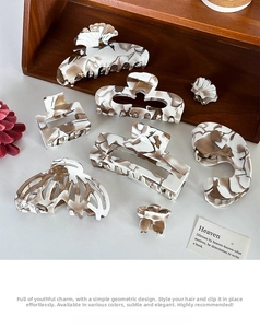 Close-up of assorted marble texture acetate hair claws in various geometric shapes
