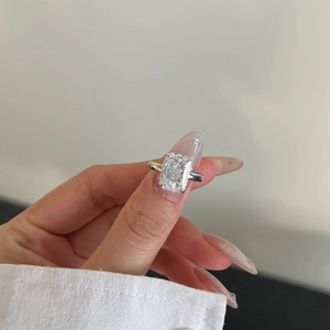 Close-up of S925 sterling silver ring with emerald cut ice-flower zircon on hand