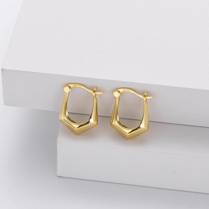 Detail of S925 sterling silver stamp on geometric gold earrings with polished finish
