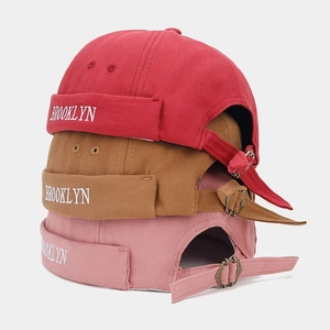 Detail of adjustable vintage Miki hats in red, brown, and pink with Brooklyn embroidery