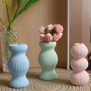 Pastel vertical stripe ceramic vases set in pink, blue, and green for home decor