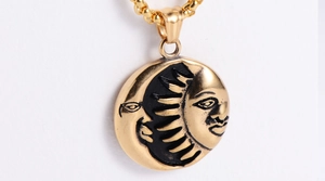 Macro detail of sun and moon face pendant with vintage black engraving and O-chain