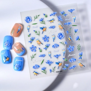 Detailed 3D embossed nail stickers featuring blue flowers, green leaves and small birds