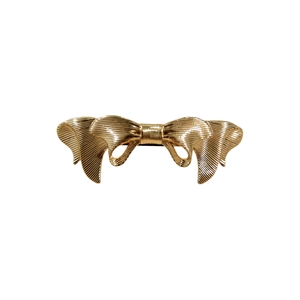 Elegant gold metal bow hair clip with textured ribbing pattern and spring closure