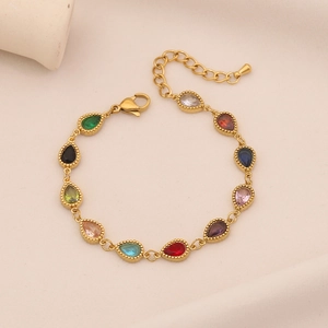 Gold stainless steel bracelet with ten colorful teardrop gemstones on a white texture