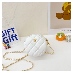 Detailed macro view of a white quilted round mini bag with gold floral hardware and chain