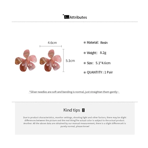 Detailed view of resin flower earrings with pink marble texture and silver needles
