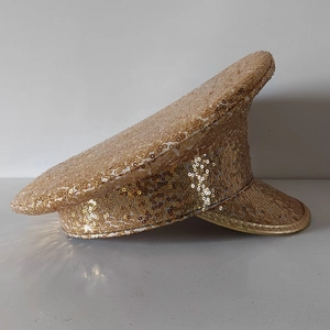 Detail view of champagne gold sequined military captain hat for party and stage performance
