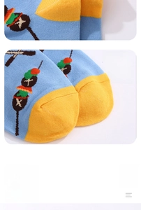 Detail of blue food print sock featuring a reinforced yellow toe and grilled skewer pattern