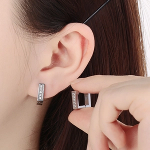 Detail of silver square stainless steel earrings featuring five inlaid white zircons