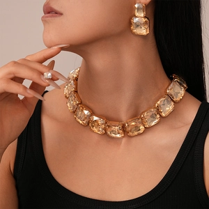 Macro shot of woman wearing champagne square crystal necklace and earrings set
