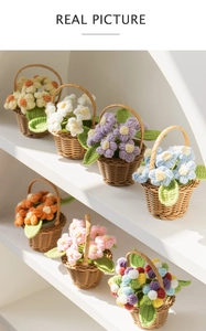 Close-up of handmade crochet flower pots in seven colors on a white display rack