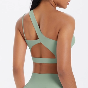 Rear view of bean green yoga set featuring asymmetrical single strap and open back design