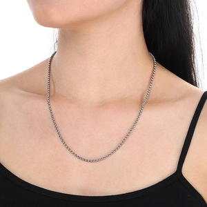 Silver stainless steel wheat chain necklace worn by a model on a white background