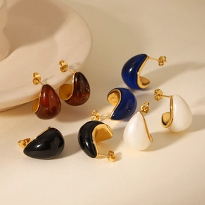 Detail view of multicolored resin teardrop earrings with elegant golden metal base