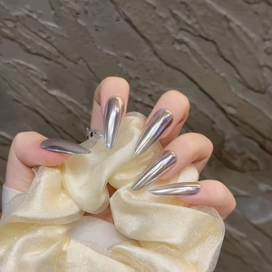 Silver chrome mirror press-on nails in long stiletto shape for a futuristic metallic look