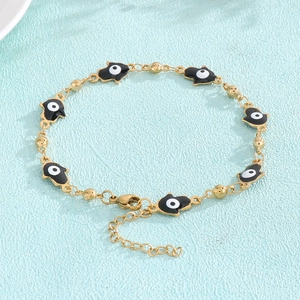 Detail of Hamsa Hand bracelet with evil eye enamel and gold bead accents