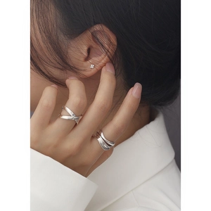 Minimalist S925 sterling silver crossover ring and clover earrings set on a female model