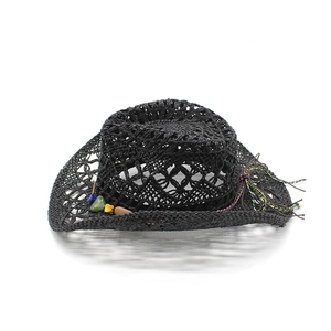 Detailed close-up of a black hollow-out straw cowboy hat with colorful stones and tassel
