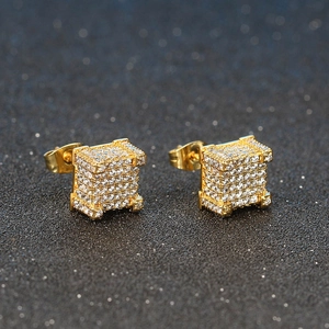 Macro shot of hip hop cubic pave stud earrings in gold with sparkling white zircons