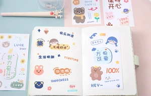 Close-up of cute cartoon stickers on a blue and pink background for journal decoration