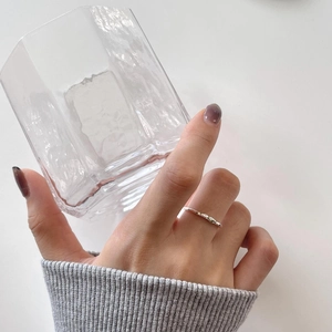 Minimalist 925 sterling silver irregular hammer pattern ring with green stones on a model