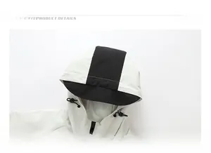 Detailed close-up of white outdoor jacket hood with black contrast drawstrings and zipper