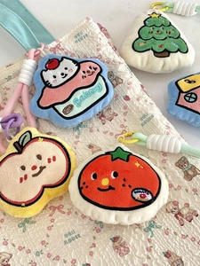 Cute embroidered plush keychain charms in various shapes on a soft quilted handbag