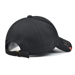 Detail view of cotton baseball cap featuring adjustable metal buckle and side brim printing