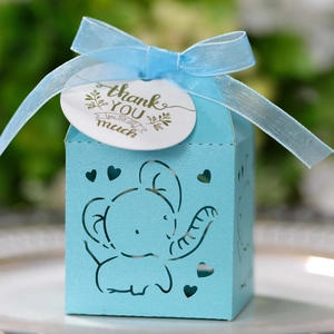 Detail of light blue elephant hollow candy box with silk ribbon and thank you tag