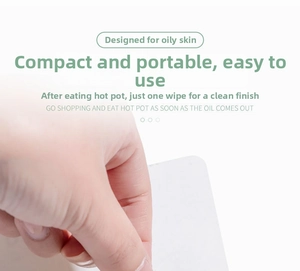 Close-up showing the process of pulling a portable facial oil absorbing sheet by hand