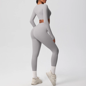 Side view of a light gray two-piece yoga set featuring long sleeve crop top and high waist leggings