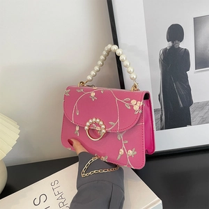 Rose red embroidered square bag with pearl handle and floral lace texture detail