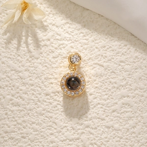 Golden dreamcatcher projection necklace with gemstone and crystals on textured background