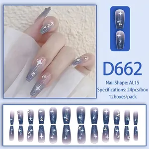 Blue-purple gradient press-on nails with white star motifs and rhinestones in coffin shape