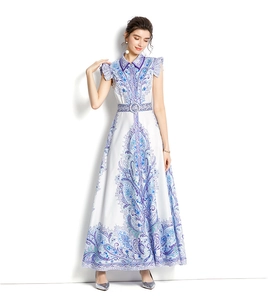 Detail of blue paisley print and sleeveless ruffled armhole on white maxi dress